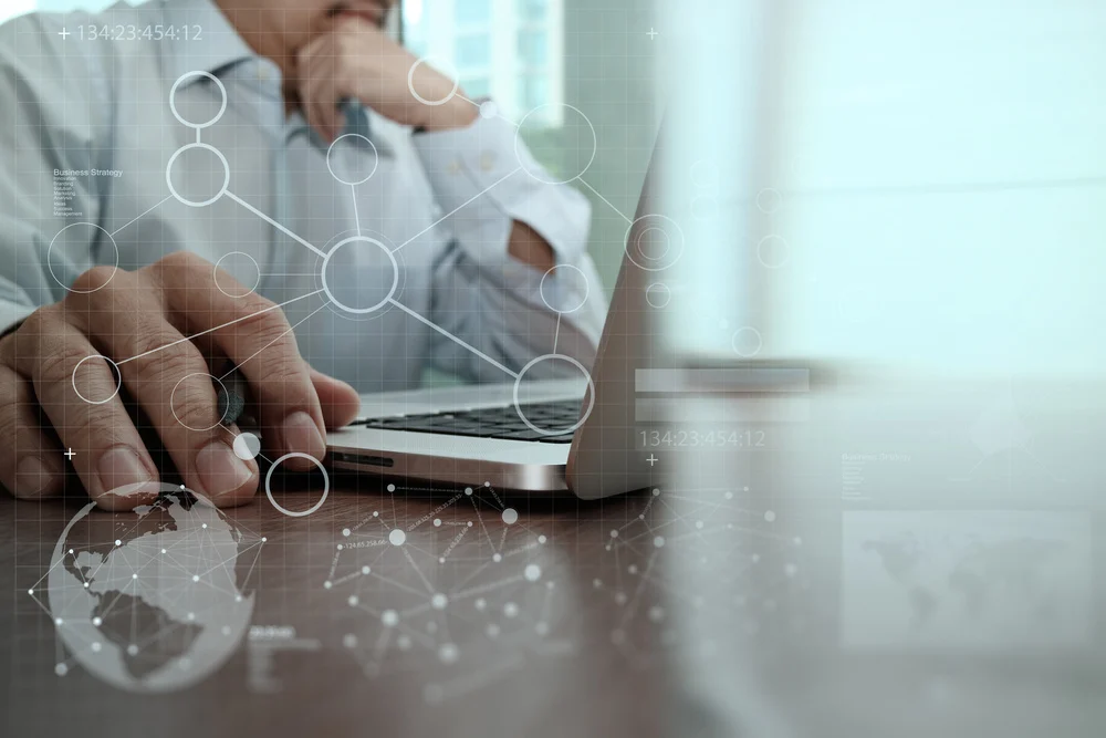 Businessman hand working with modern technology and digital layer effect as business strategy concept